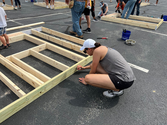 Our founder and lead designer works alongside fellow volunteers to build wall framing during a Habitat for Humanity Serve Day project, helping construct a home for a family in need