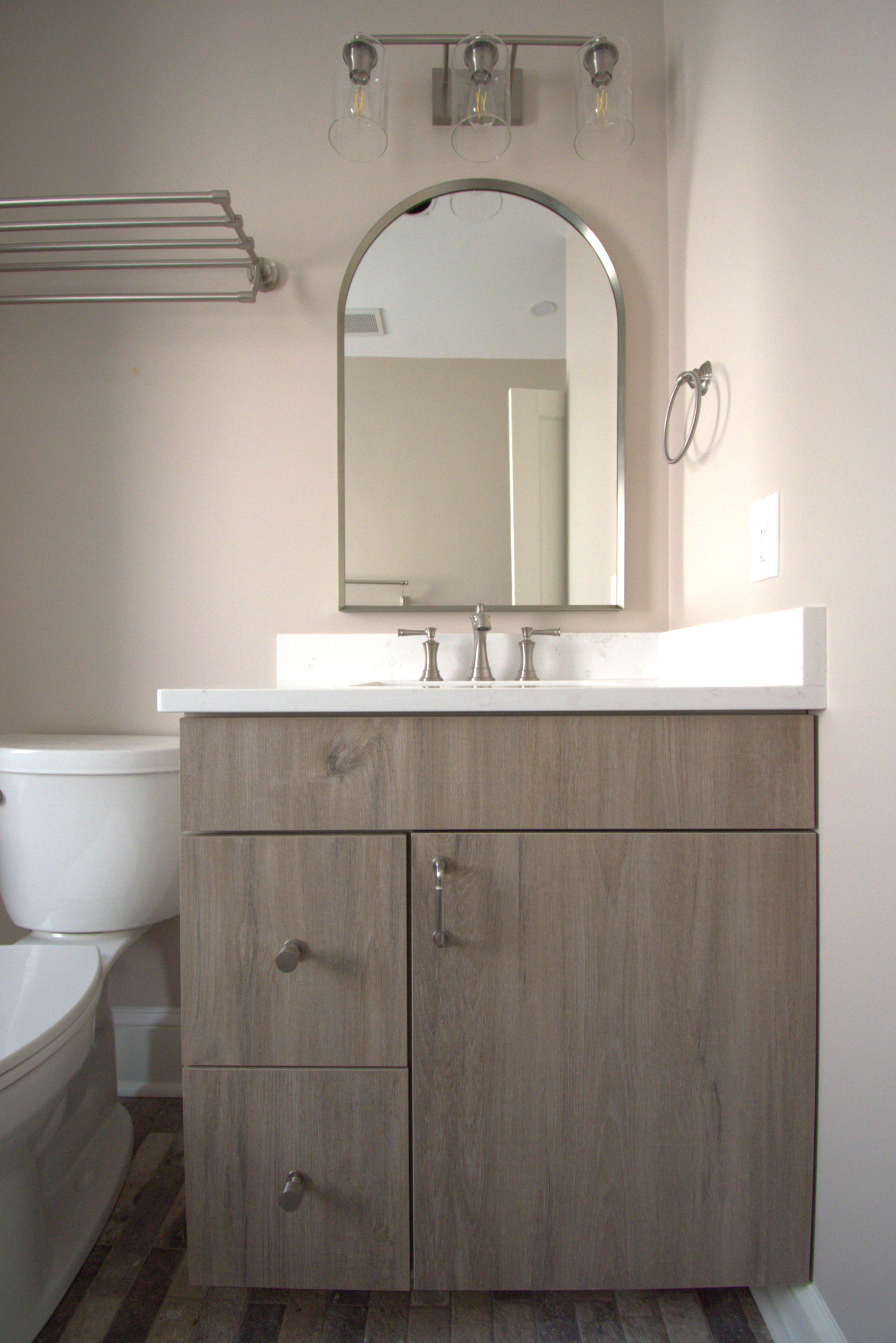Bathroom with arched mirror brushed nickel finishes industrial brick porcelain tile